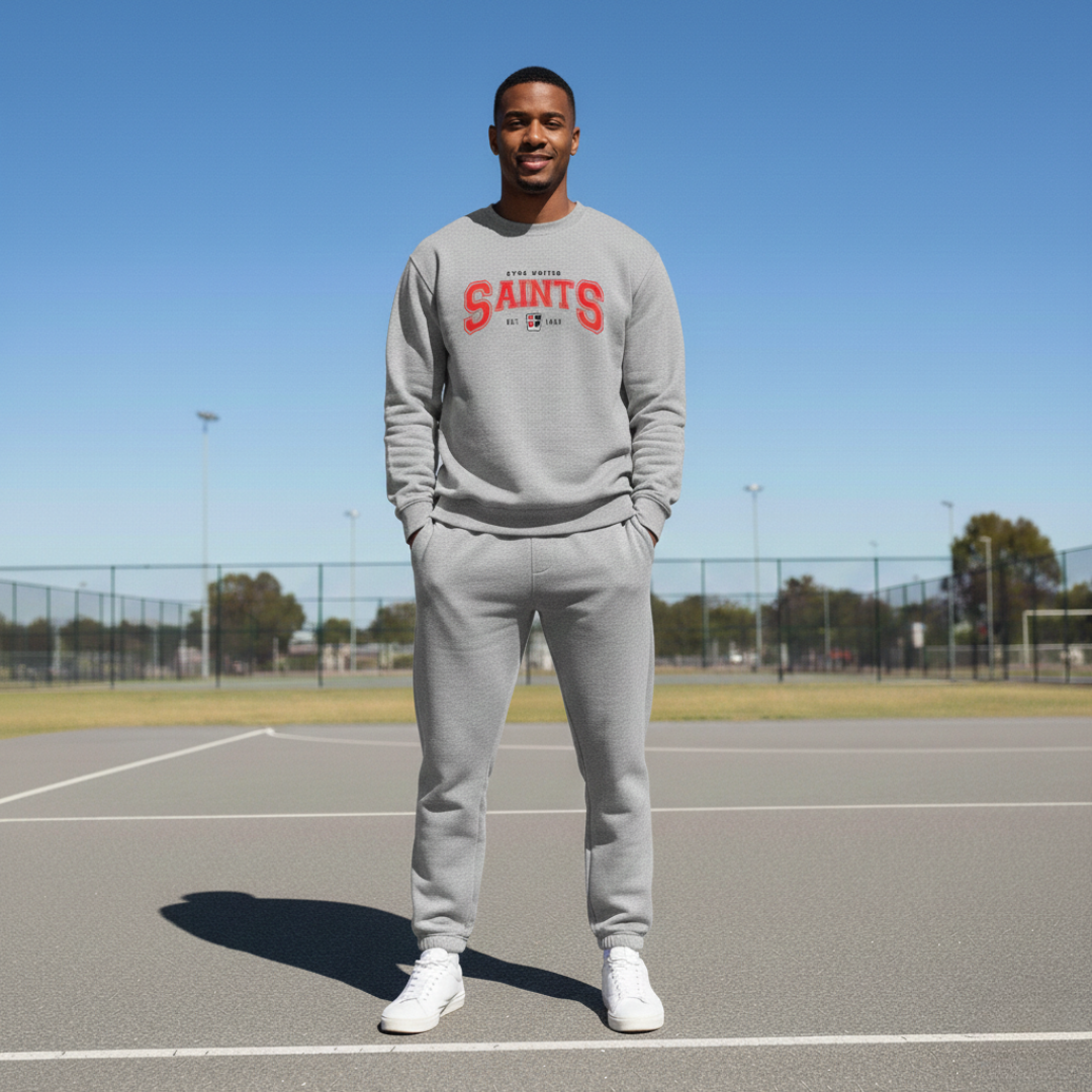Person wearing a gray 'SAINTS' sweatshirt on a tennis court