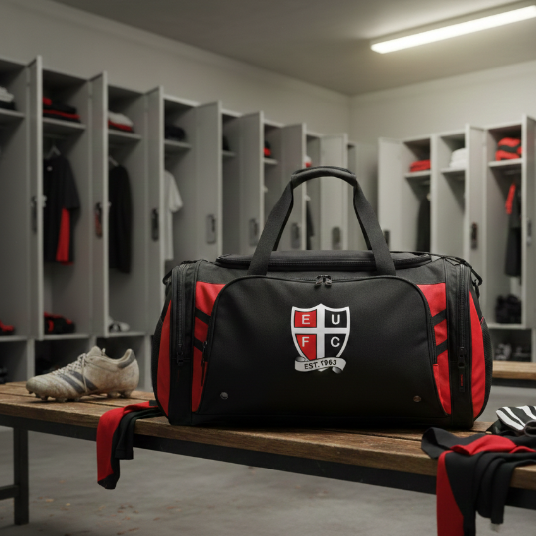 Black and red sports bag with a logo on a bench in a locker room.