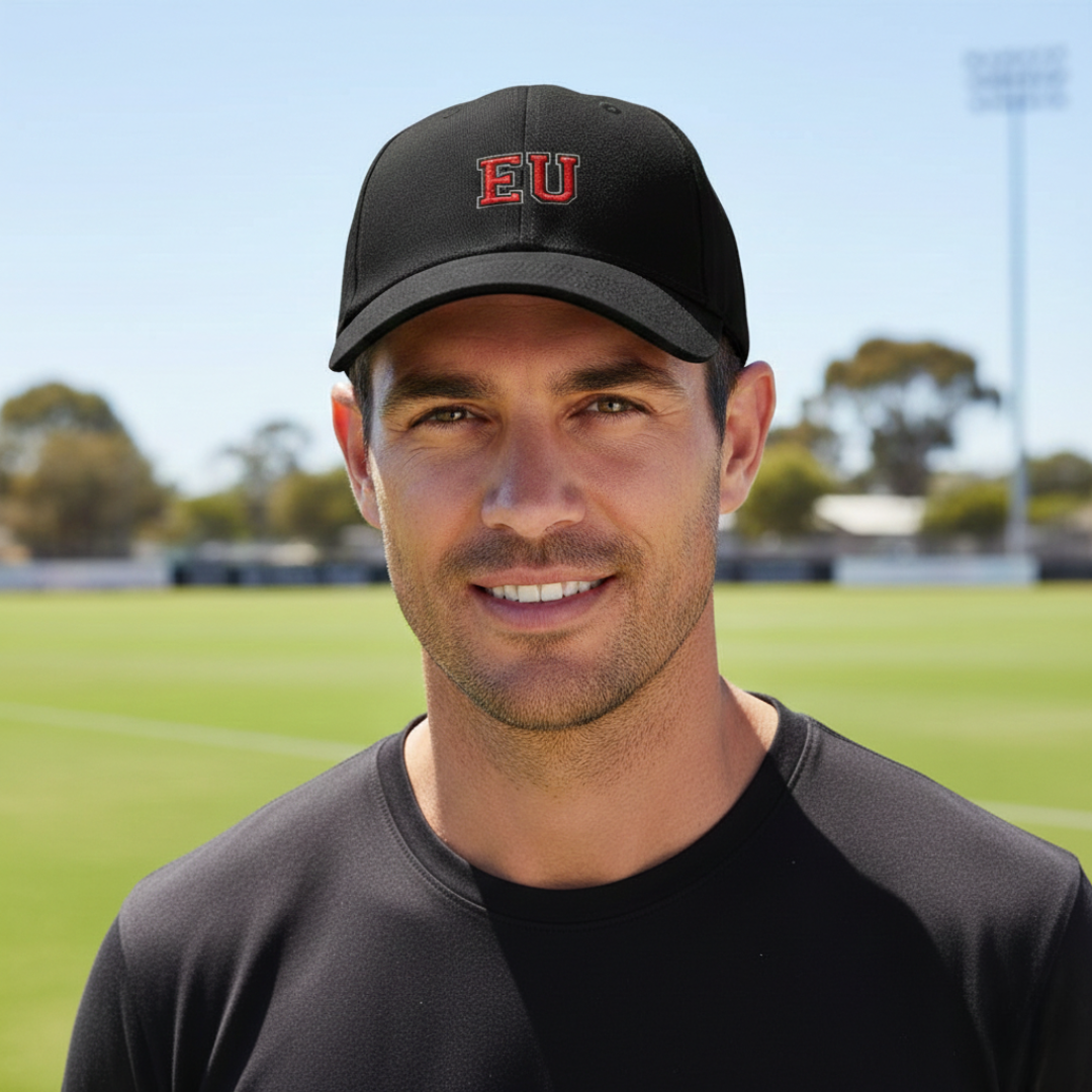 Man wearing EU embroidered cap on a football oval