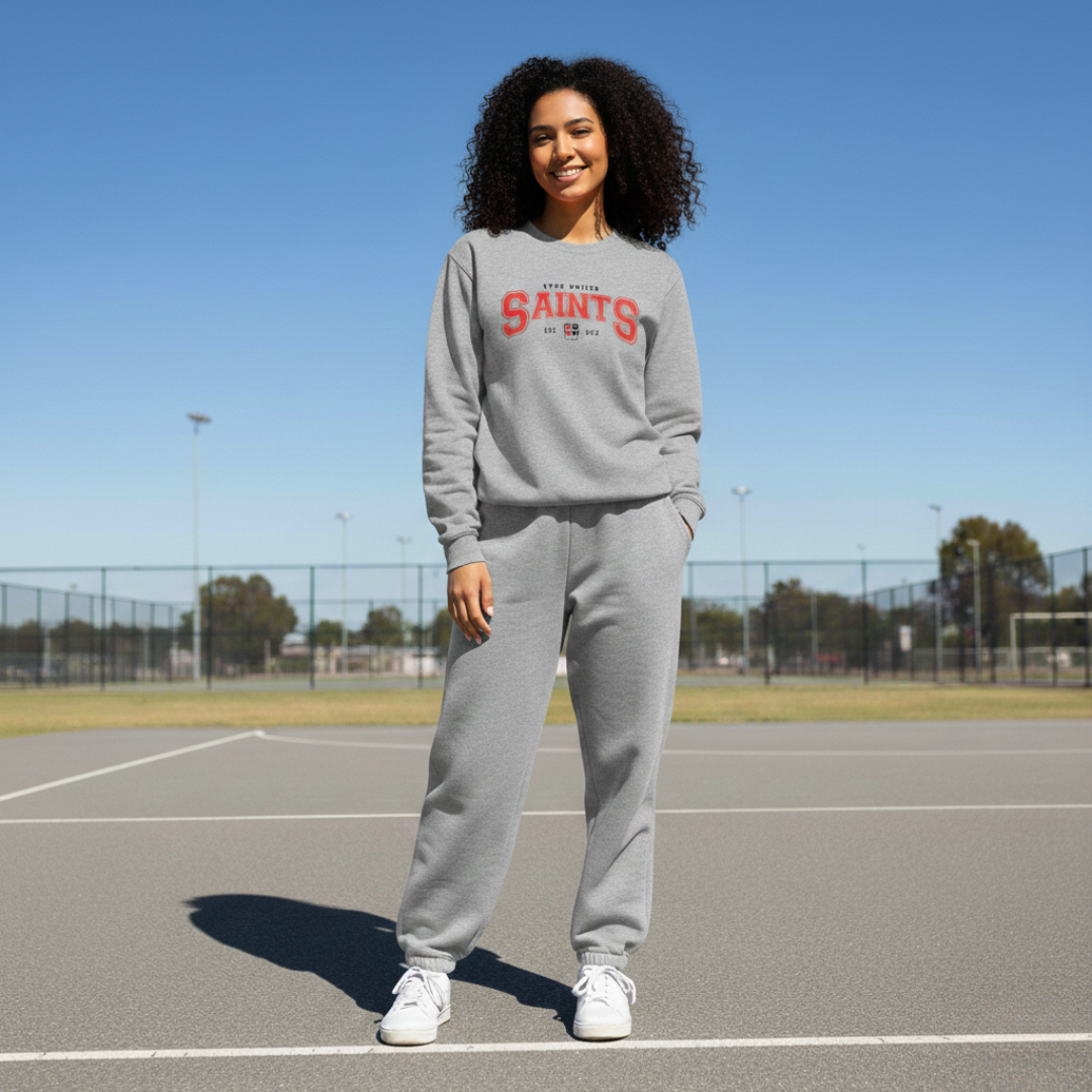 Person wearing a gray sweatshirt with 'SAINTS' text on a tennis court