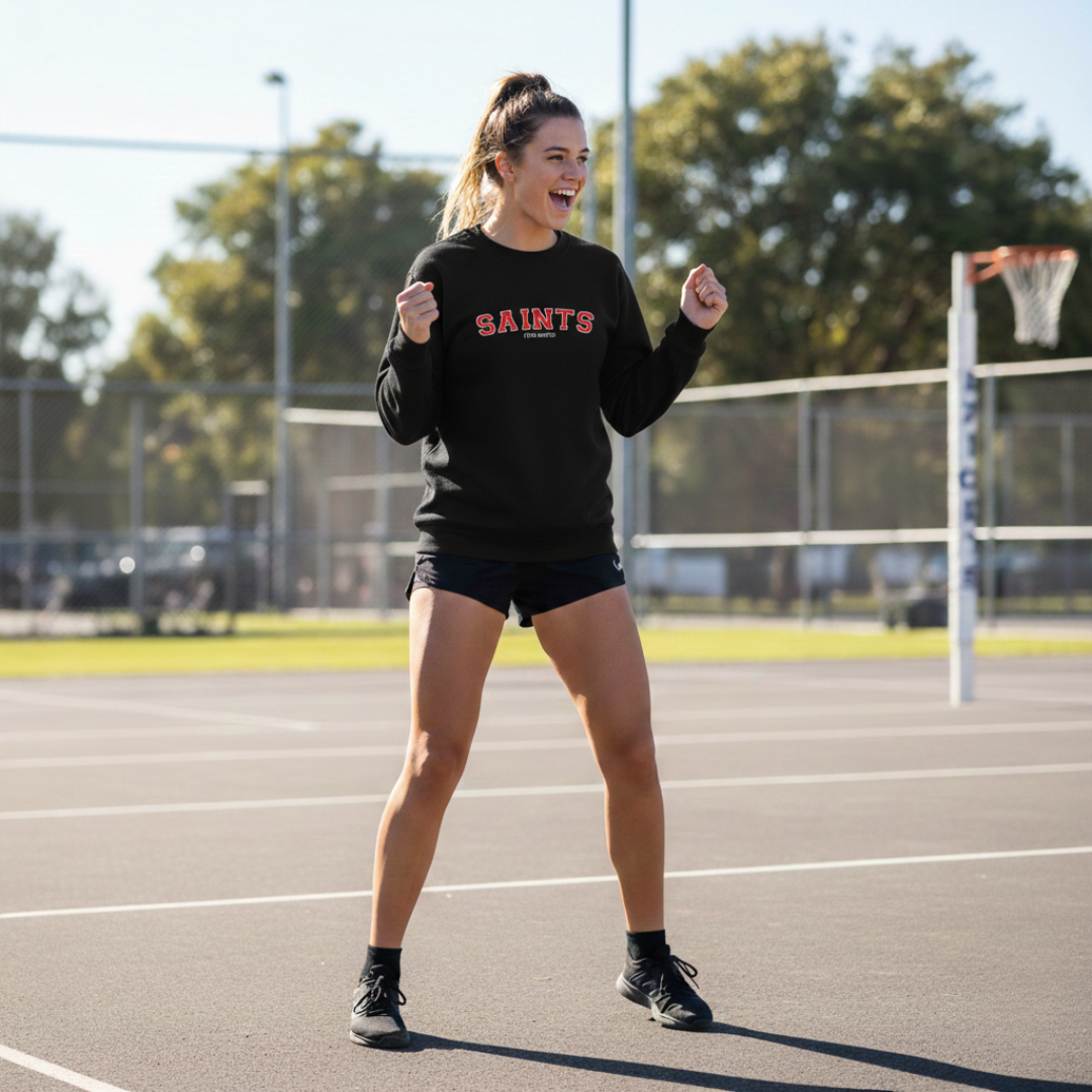 Woman in black 'SAINTS' sweatshirt on a track and field