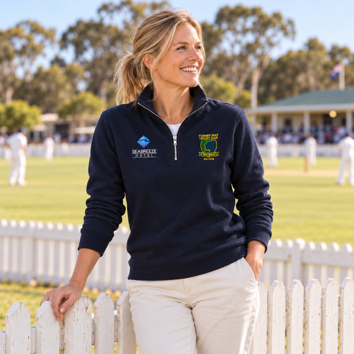 Woman wearing the Tumby Bay Cricket Club navy 1/4 zip at the cricket